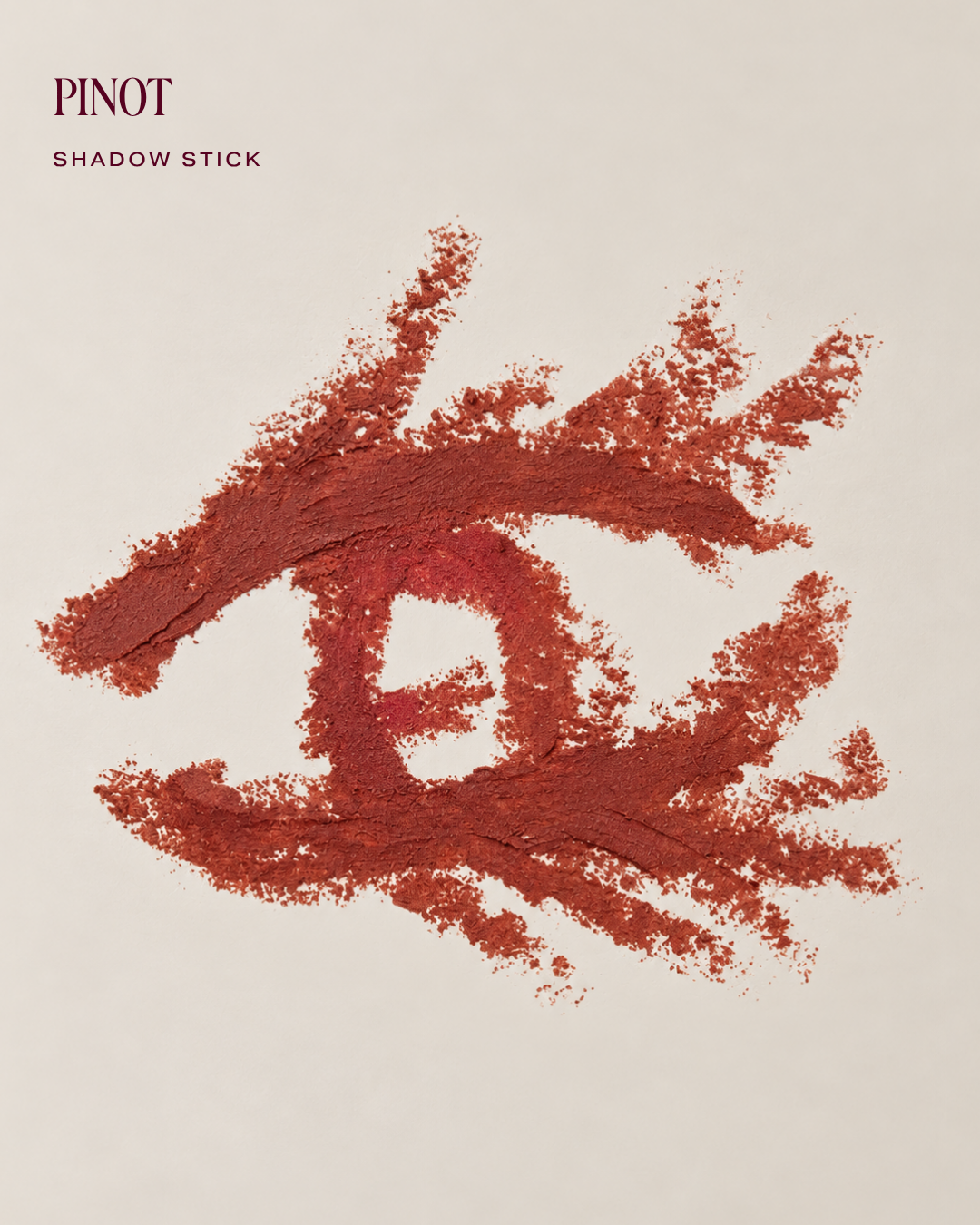 Shadow Stick swatch in Pinot, a brick red