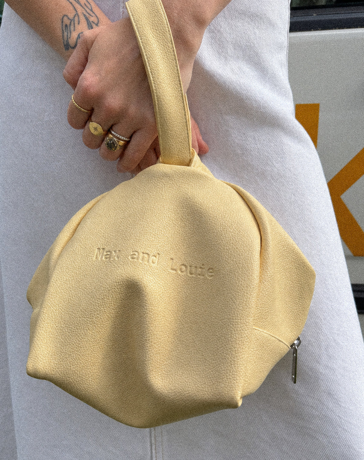 The Face Case makeup bag carried by its wrist strap