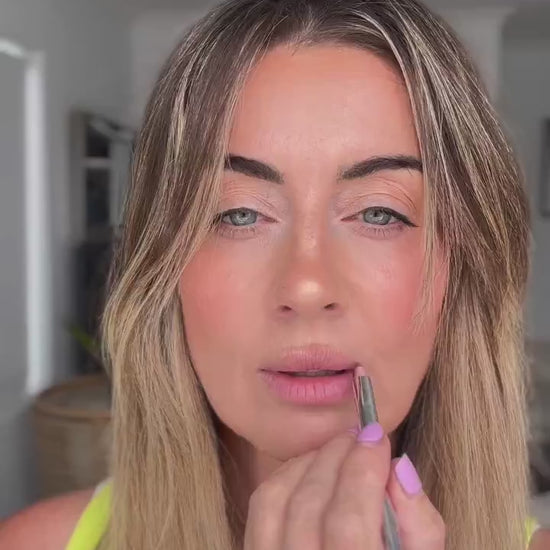 Nat applying Hydra Lip Oil over a lined lip