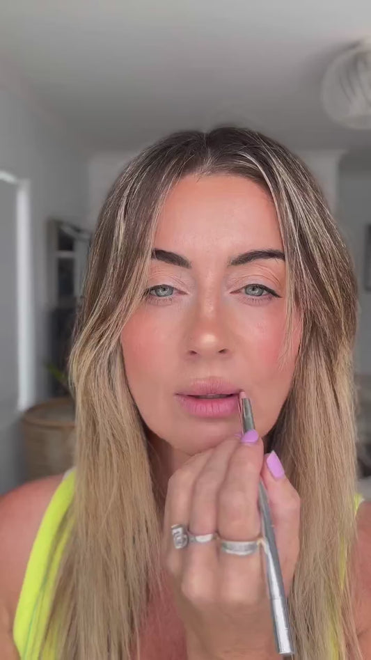 Nat applying Hydra Lip Oil over a lined lip