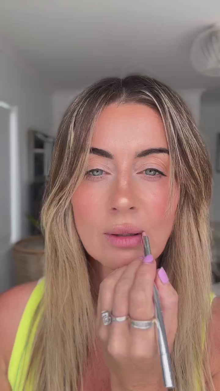 Nat applying Hydra Lip Oil over a lined lip